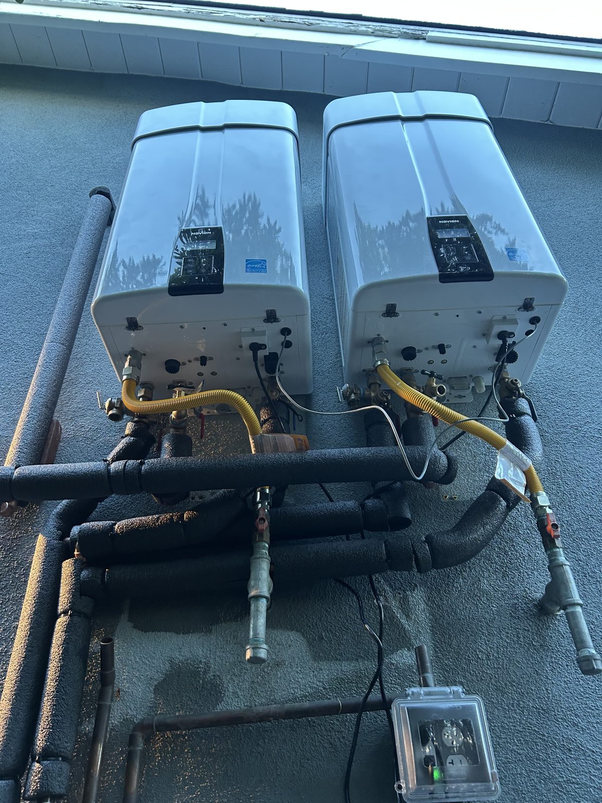 After: new Navien NPE-240A2 tankless cascade system with rebuilt gas and water piping, installed by Efficient Water Heaters Inc.